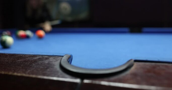 Female player shots ball to push goal into pocket on billiard table. Ball misses target. Entertainment and game concept slow motion
