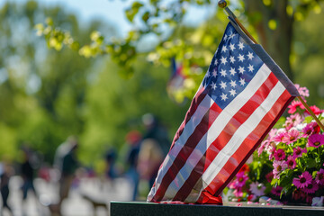 Old Glory Stands Amidst Flowers at a Memorial Day Commemoration