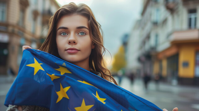 Woman holds the European Union flag in her hand. EU flag at a demonstration for EU accession