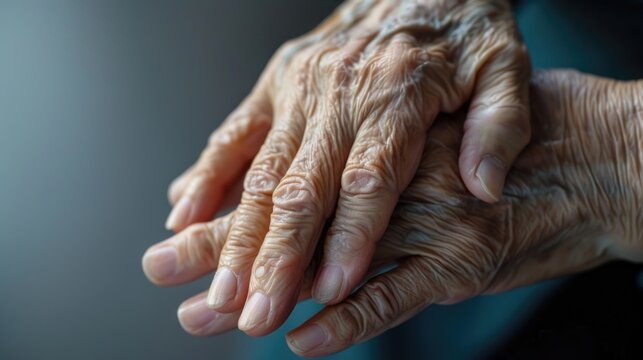 Elderly hands clasped together in detail. Close-up photography of aged skin
