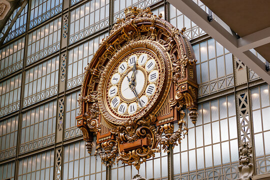 Paris, France - JUNE 06, 2014: Orsay museum. View of the main hall of the museum, the golden clock and the glass canopy background