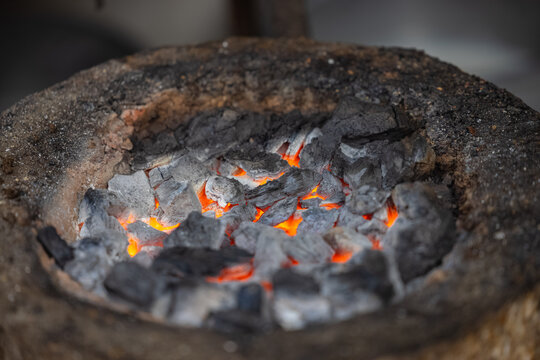 Burning coal on mud stove or chulha at tea shop.