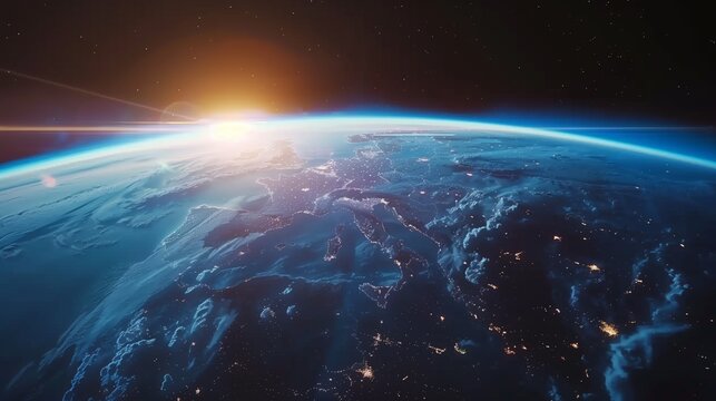 Stunning view of Earth from space showing continents lit by city lights under a sunrise.