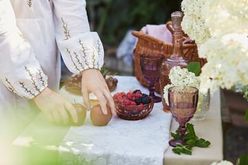 Essence of cottagecore aesthetic, rustic simplicity and the timeless beauty of connecting with nature, as experienced by a woman engaging in the art of simple living