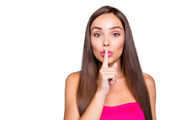 Fototapeta premium It's top secret information! Do not tell to anyone! Close up studio photo portrait of cute sweet winsome pretty excited glad woman holding forefinger near lips isolated on vivid shinny background