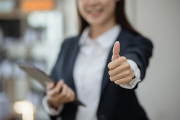 Portrait of business woman holding digital tablet in company office.