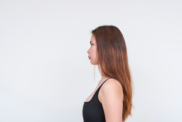 Young Asian woman in black bodysuit posing gracefully, isolated on a white background