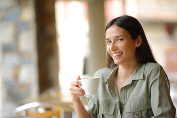Restaurant customer holding coffee cup looking at you