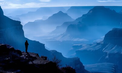 A hiker silhouetted against the Grand Canyon on the South Kaibab Trail in the morning