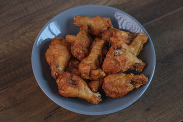 Delicious fresh crispy chicken on a dark wood background. Unhealthy food, fast food