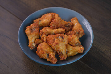 Delicious fresh crispy chicken on a dark wood background. Unhealthy food, fast food