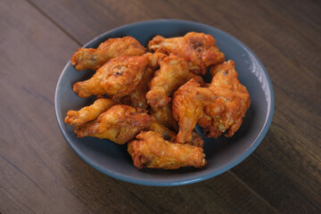 Delicious fresh crispy chicken on a dark wood background. Unhealthy food, fast food