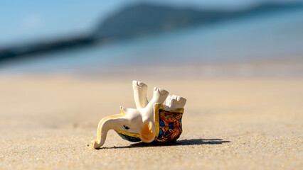 elephant statuette on the beach, sea holiday concept