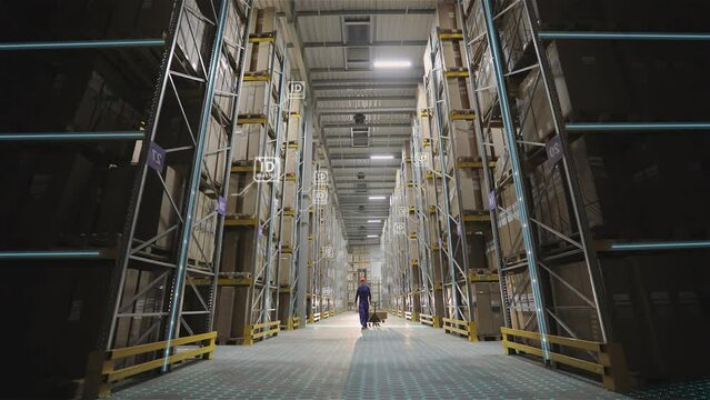 Gradual switching on of lights in a factory warehouse, concept. A worker walks along the rows of a warehouse.Morning at the factory. Warehouse with factory products.
