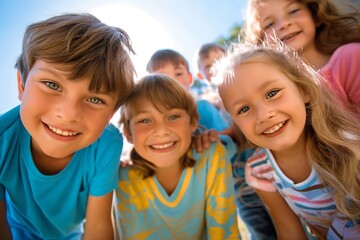 Cute little children playing together and having fun. Group portrait of happy kids huddling, looking down at camera and smiling. Low angle, view from below. Friendship concept