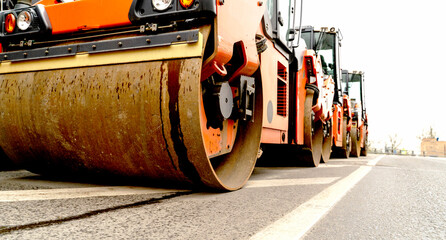 asphalt paver or roller on the road before laying asphalt