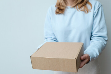 Woman hand with a delivery box on white background. Delivery concept. Delivery courier and shipping service concept.