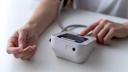 girl measures blood pressure with a tonometer