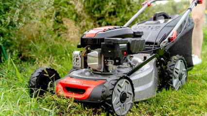 lawnmower on mowed lawn on a sunny day