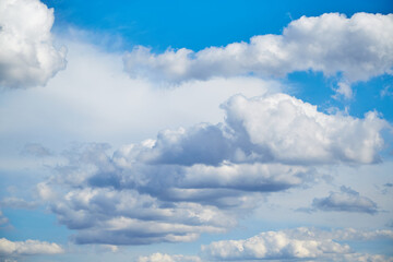 White clouds in the blue sky, sunlight on white clouds in the sky, sky landscape with white clouds