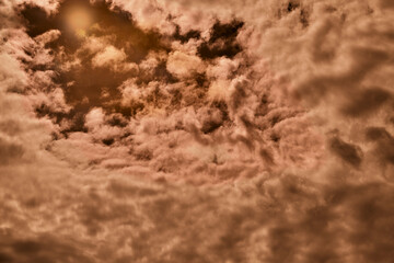 Bright orange clouds in the sky, an unusual cloud view, abstract background with orange clouds