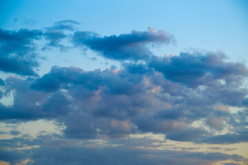  evening light on the clouds in the sky, sun-kissed; sublime; celestial panorama; atmospheric drama