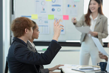 Fototapeta premium Group of asian business people working and brainstorming in workshop and analyzing marketing reports startup project infographics in the office, Sales and business plans, presentation ideas concept.