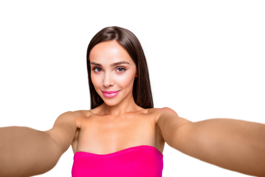 Self-portrait of nice charming smiling straight-haired brunette girl, lady in pink top. Isolated over bright vivid turquoise teal background