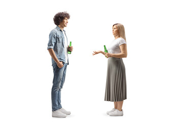 Full length profile shot of a young man and woman holding bottles of beer and talking