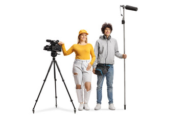 Full length portrait of a female camera operator and man with a microphone