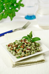 Fresh broad beans with ham and mint.