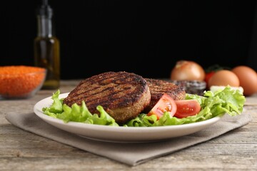 Vegetarian product. Tasty lentil cutlets served on wooden table