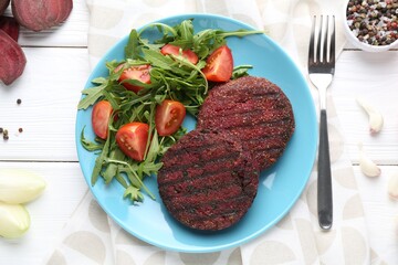 Vegetarian product. Tasty beetroot cutlets served on white wooden table, flat lay