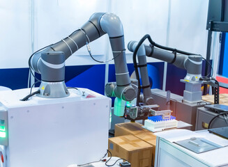 Robot arm with test tube for biological experiments in laboratory