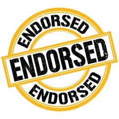 ENDORSED text on yellow-black round stamp sign