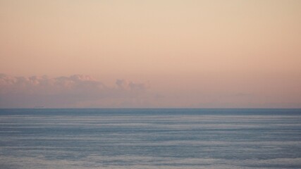 Horizon over the sea minimalist seascape with space for text, calm blue sea and sunset sky great panoramic aerial view.
