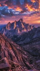 Obraz premium A panoramic view of a jagged mountain range at sunset, painted in fiery orange and purple hues
