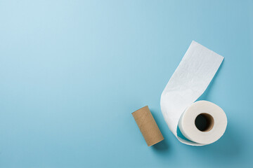 Top view of toilet paper roll on blue background