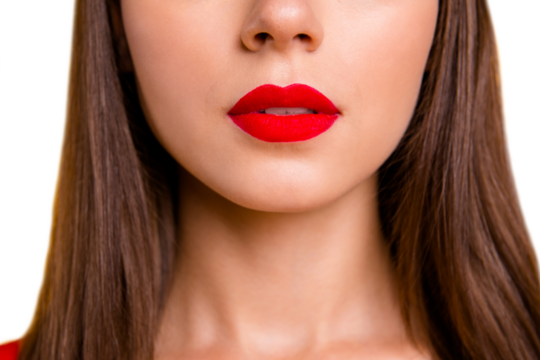 Close up half face crop portrait of brunette woman with red lips slightly opened her mouth isolated on vivid yellow background