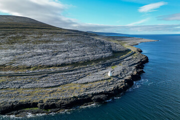 Black Head Lighthouse in the rocky landscape of the Burren, Ireland