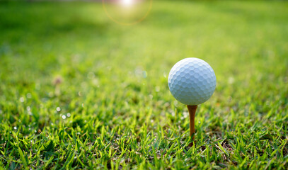 golf balls and golf equipment are ready to hit the sunlit green lawns in summer.