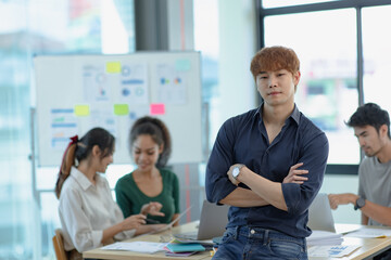 Asia young creative man in smart casual wear looking at camera in office workplace.