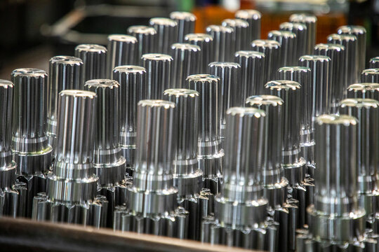 metal components in a production line. machined metal parts and components on manufacturing line in a factory after shaped in a cnc machine.