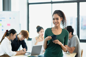 Asia young creative people in smart casual wear looking at camera in office workplace.