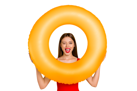 Beach style! Travel daydream concept. Positive girl look through colorful rubber rings enjoying rest isolated on yellow background