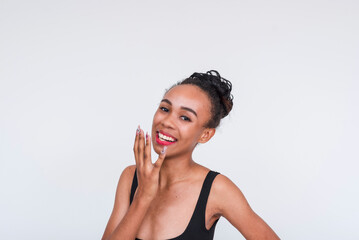 Beautiful mixed race woman smiling in black bodysuit, isolated on white