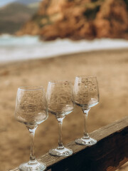 empty glasses against the backdrop of the beach