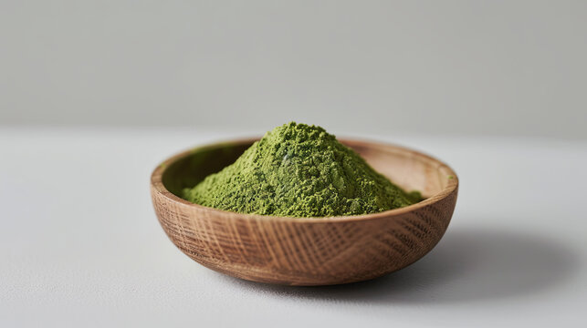 Green matcha powder for making drink on wooden background