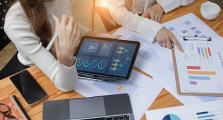 Technology and financial advisory services concept. Business teamwork and working on digital laptop computer with advisor showing plan of investment to clients at table office. Digital marketing.