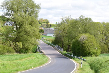 narrow Eifel road in springtime, valley curvey